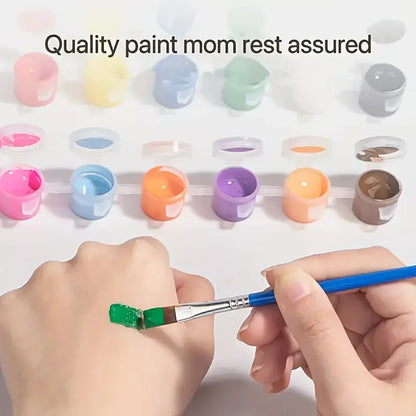 A hand holding a paintbrush with green paint, surrounded by small paint pots in various colors.