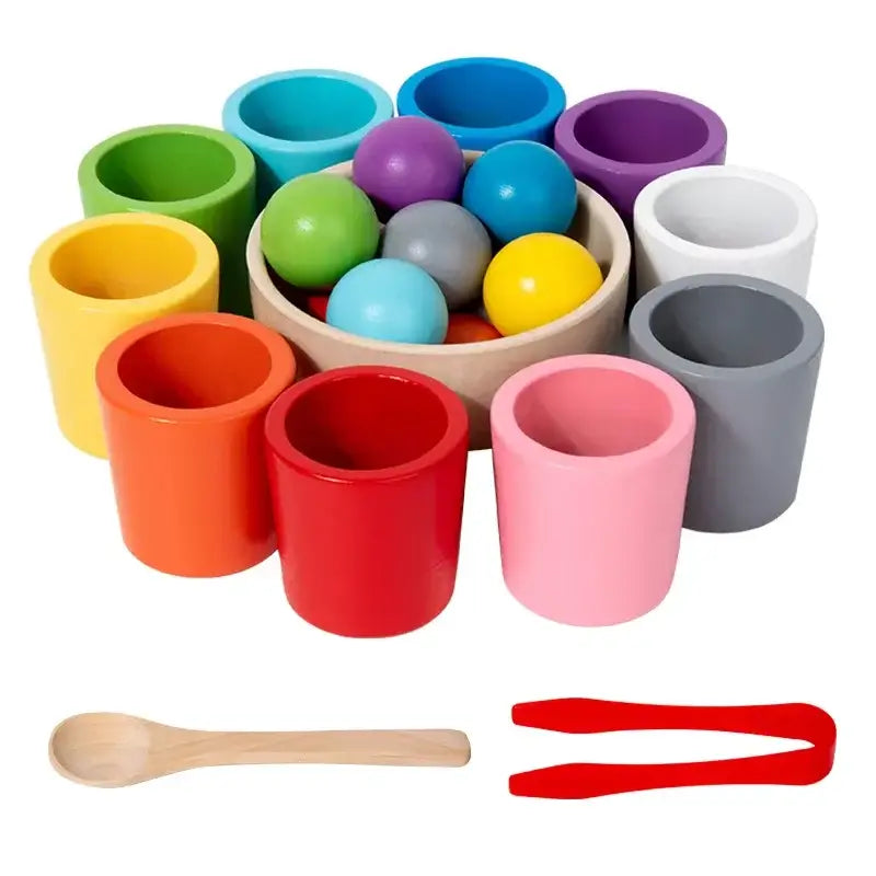Colorful wooden sorting cups in various shades with balls and tools, including a wooden spoon and red tweezers.