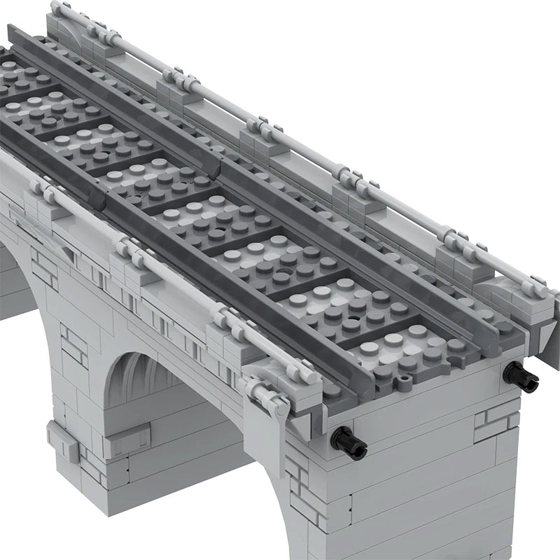 Gray building block model of a traffic bridge with train tracks, featuring detailed arches and connectors.