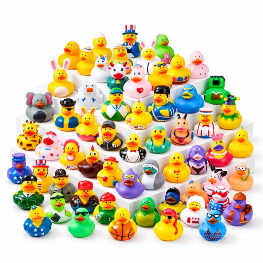 A large assortment of colorful rubber duck toys arranged on white display blocks. The set includes many yellow ducks plus ducks dressed in different outfits and decorated with various patterns, plus a yellow badge in the top right that reads '120 pcs'.