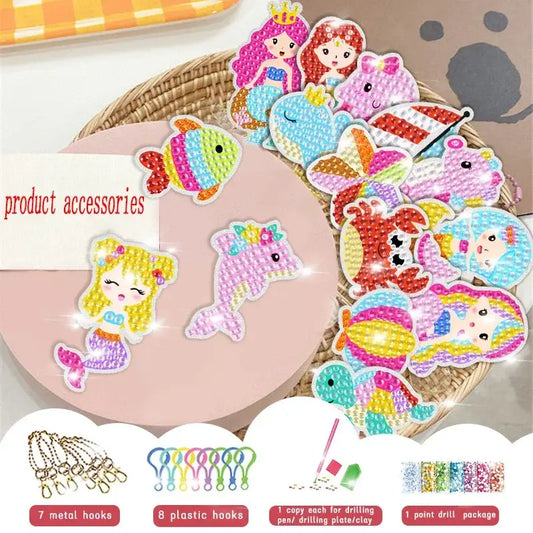 Colorful diamond painting keychains featuring mermaids, fish, and other animals, arranged in a woven basket.