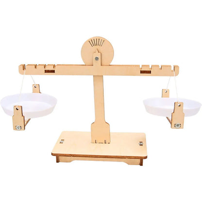 Wooden balance scale model with two white bowls, designed for educational STEM projects.