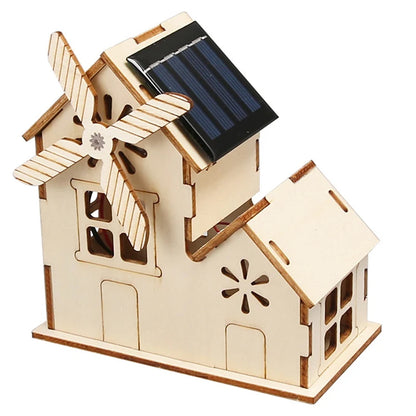 Wooden model house with solar panel and windmill, featuring cut-out windows and decorative details.