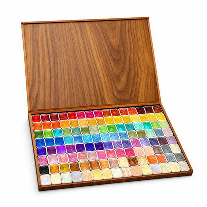 Glitter watercolor set on a white studio background